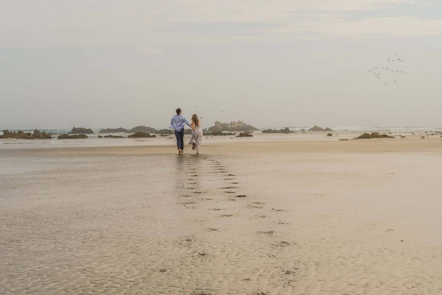 Samantha and Estiaan walking on the beach